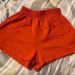 These shorts are a medium, they are plain orange with Cheer leader on the back.